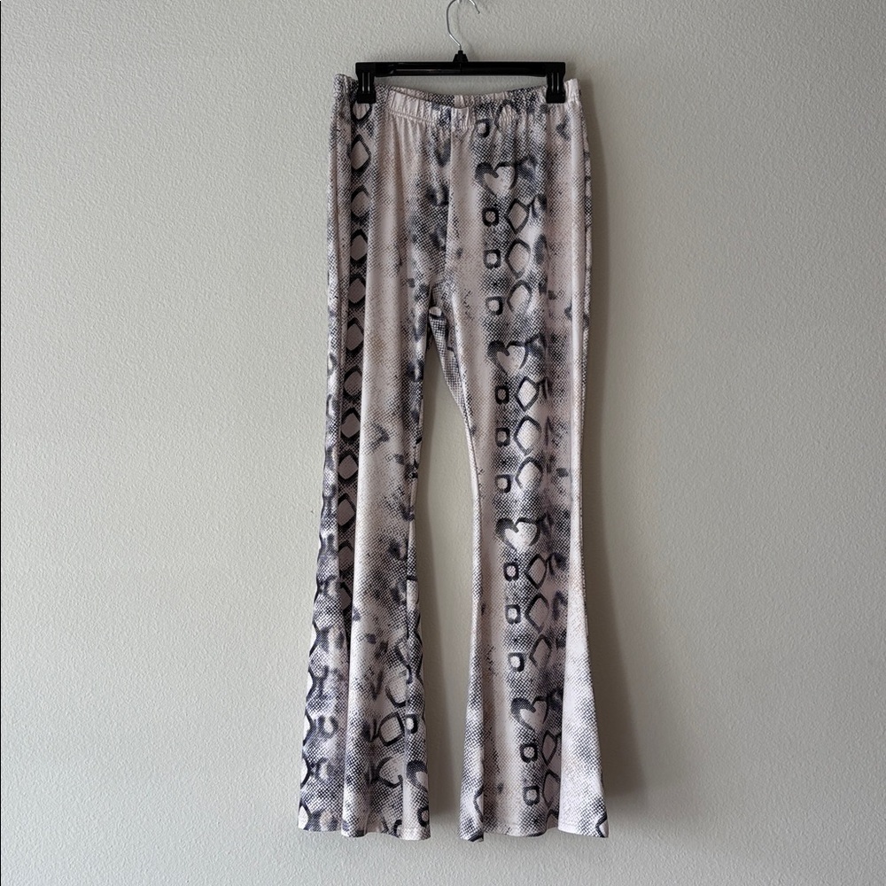 Snake Print Flared Pants In cream with black accents. Elastic waistband.
